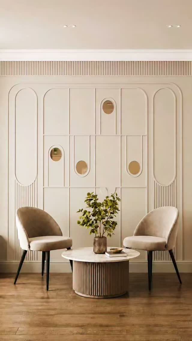 Geometric cream wall paneling with oval and circular shapes behind two chairs and a coffee table.