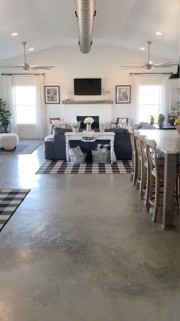 Polished concrete flooring stretching through a modern open-concept living and dining area.