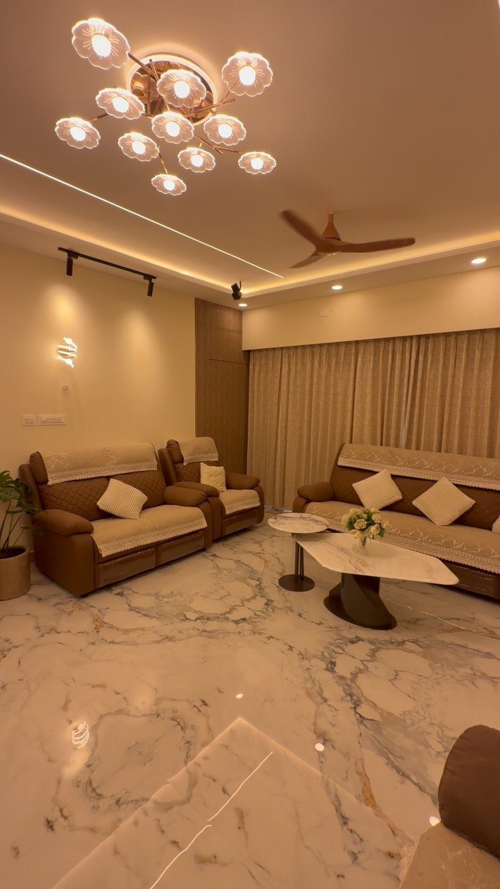 Polished white marble flooring with grey veins in a modern living room setting.