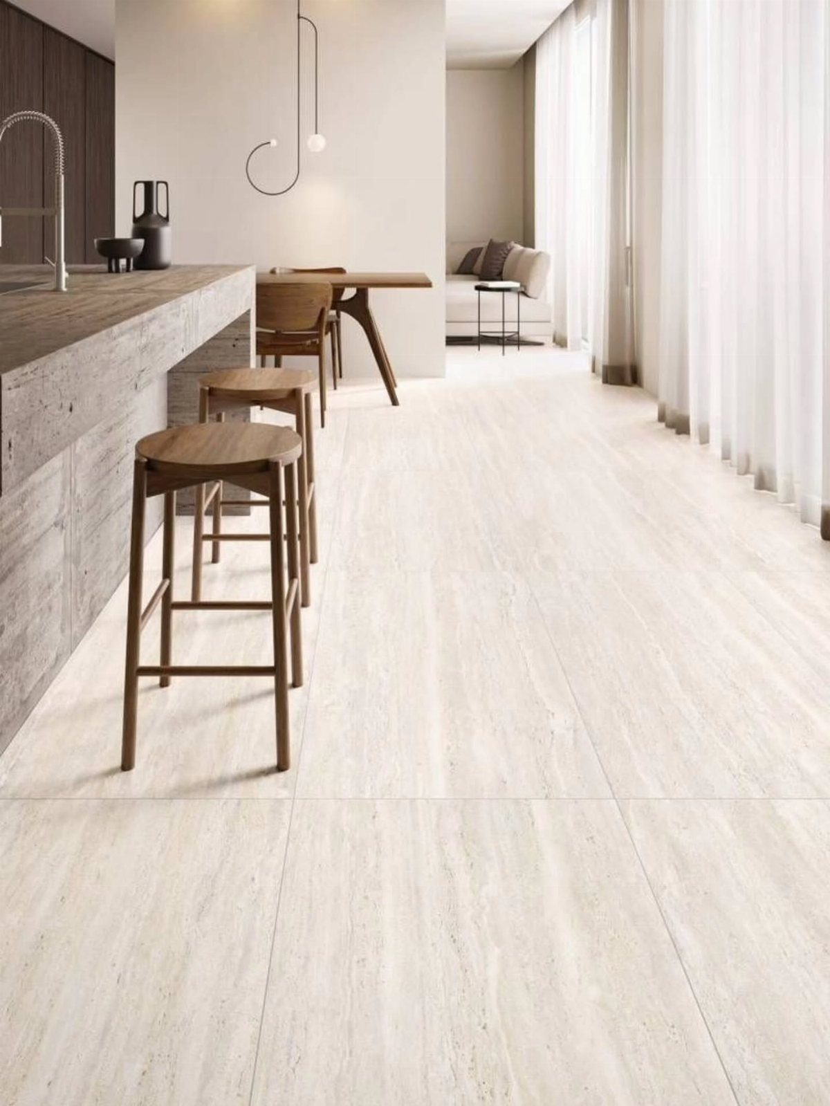 Light beige stone tile flooring in a modern open-concept living and kitchen space.