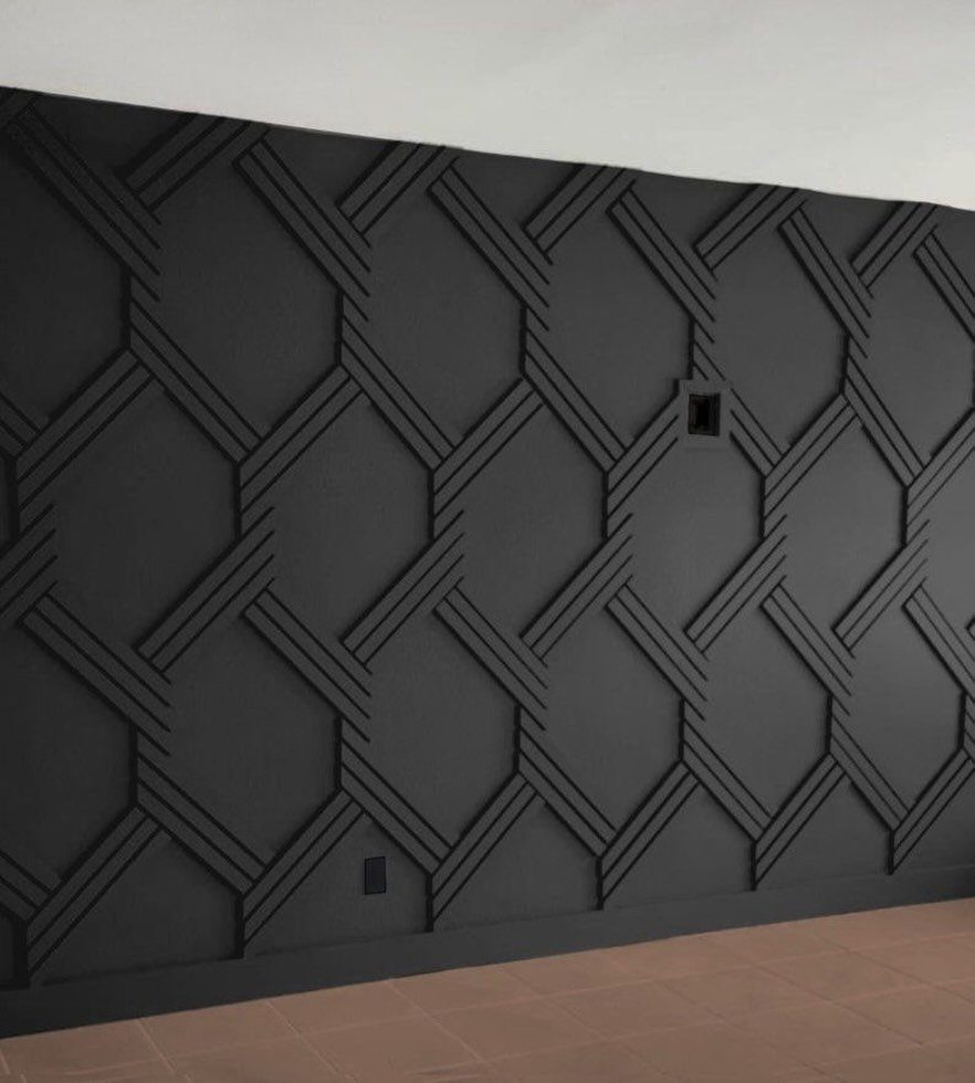 Dark charcoal wall with a raised three-dimensional geometric pattern of interlocking lines.