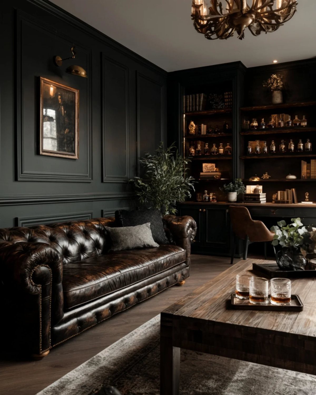 Dark paneled walls behind a brown leather Chesterfield sofa in a moody living room.