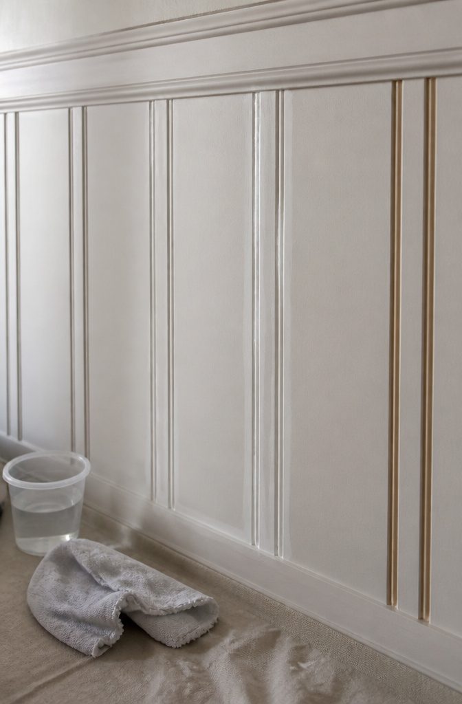 How to Paint Wall Paneling: 6 Steps for a Smooth, Lasting Finish 3 Close-up of spackled wooden paneling with tools nearby.