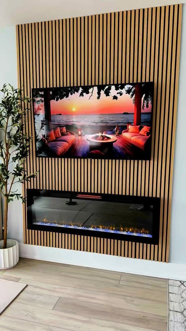 Vertical light wood slats form an accent wall featuring a mounted television and a modern electric fireplace.