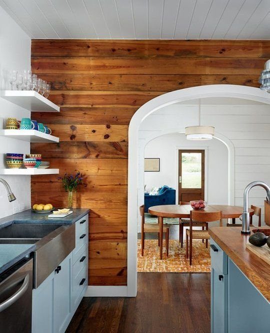 9 Natural Wood Shiplap Wall Ideas for Every Room 8 Natural wood shiplap wall in a kitchen featuring an arched doorway and blue cabinetry.
