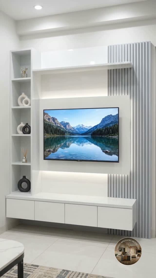 White modular wall-mounted TV unit with shelving and storage against a grey fluted wall.