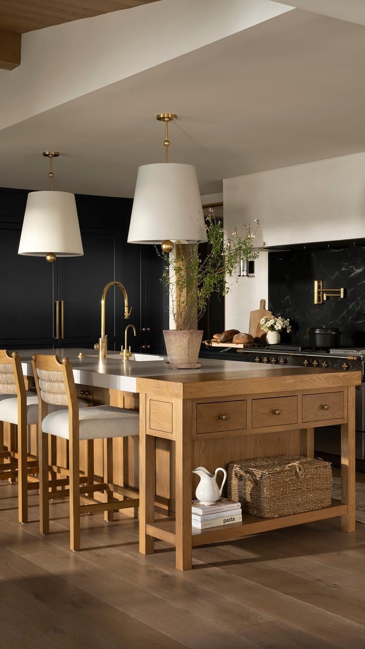 Light wood flooring in a modern kitchen with a large wooden island and gold accents.